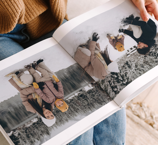 Open photobook featuring photos of parents playing with their children