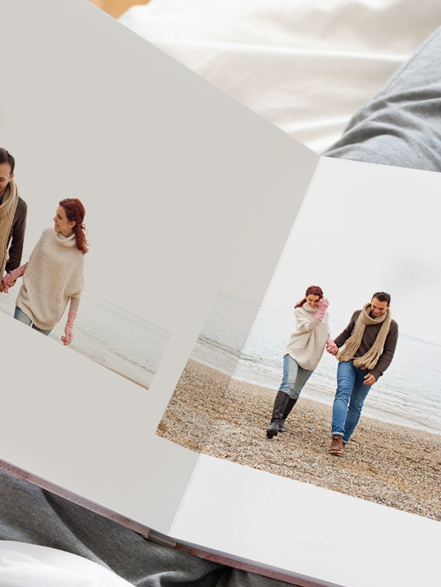 Open photobook with photos of children playing in the ocean