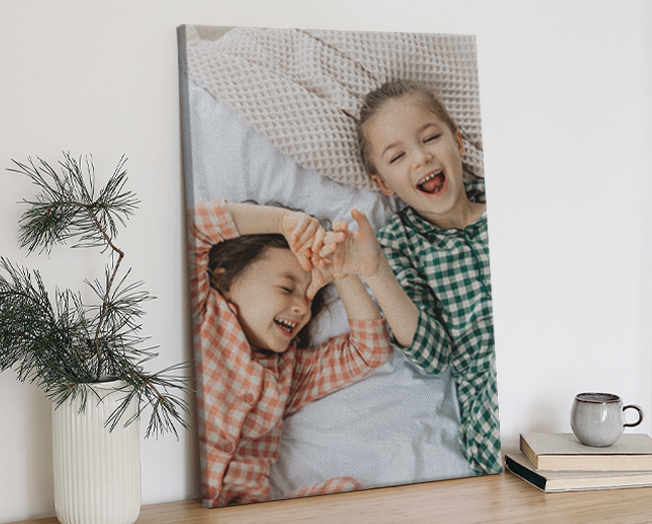 Framed wooden print against a wall with a parent and baby with the text 'That Forever Kind of Love'